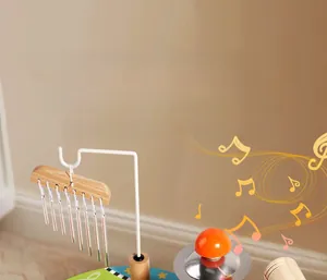 Close-up of metal wind chimes and cymbal on a minimalist wooden musical toy