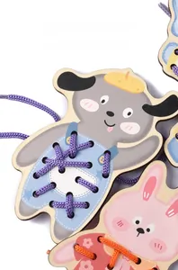 Macro detail of wooden animal threading boards with colorful cotton ropes for motor skills