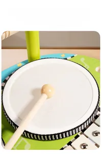 Detail of multi-functional wooden drum set with white PU leather surface and metal xylophone