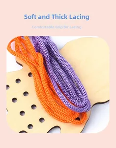Close-up of thick purple and orange nylon threading ropes on a wooden activity board