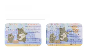Close-up of four children's music sheets featuring easy numbered notation and cartoon bear illustrations