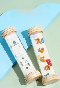 Close-up of wooden sensory rainmaker toys with UV-printed leaf patterns and small beads