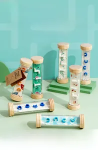 Close-up of wooden palm balance maze toy showing clear plastic tube and inner marble track