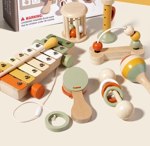 Macro detail of wooden montessori musical toys in sage green and muted orange tones