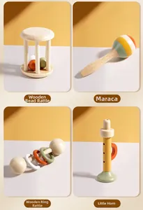 Detail of wooden baby rattle set including maraca and horn for sensory development