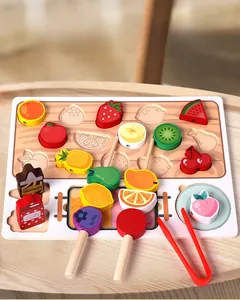 Macro shot of wooden fruit blocks and tweezers on base for fine motor skill development