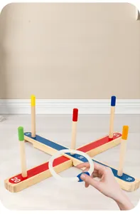 Action shot of hand tossing a cotton rope ring onto a wooden scoring base for kids