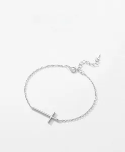 Detailed macro view of S925 sterling silver minimalist cross bracelet with adjustable link chain