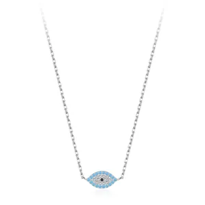 Macro shot of silver Evil Eye necklace with turquoise and pavé cubic zirconia details