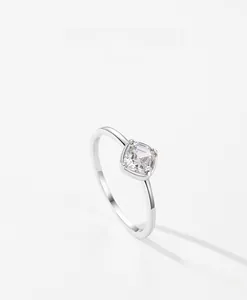 Détail macro d'une pierre solitaire carrée sur un anneau minimaliste en argent fin