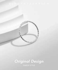 Detailed macro view of silver S925 sterling silver ring with diamond-cut sparkling texture