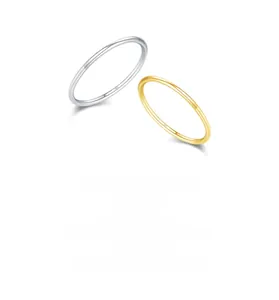 Macro detail of minimalist S925 sterling silver and gold rings showing S925 engraving