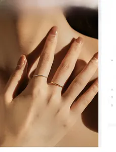 Detail of minimalist s925 silver stacked rings in polished gold and silver finishes