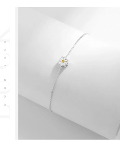 Macro view of S925 sterling silver daisy bracelet with white petals and yellow center