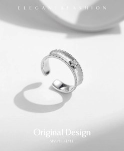 Macro detail of S925 sterling silver matte ring with pavé zircon flower and milgrain edge
