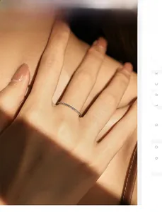 Detailed view of a silver minimalist twisted rope ring on a finger with artistic lighting