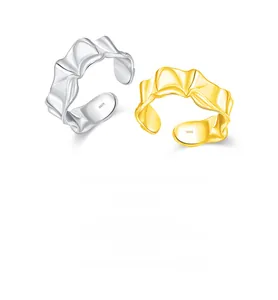 Close-up of S925 sterling silver rings with irregular ruffled textures in silver and gold