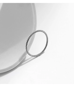 Macro detail of a vintage S925 sterling silver twisted rope ring with oxidized texture