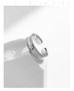 Macro detail of S925 sterling silver matte ring with star-set zircon and beaded edges