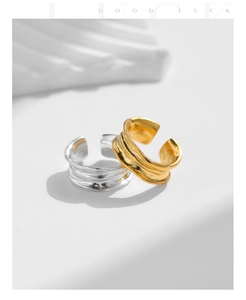 Macro detail of gold and silver S925 sterling silver rings with irregular hammered texture