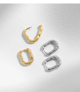 Detailed close-up of S925 sterling silver earrings with textured rock pattern finish