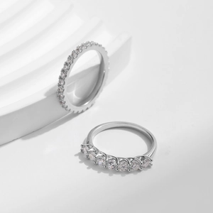 Elegant S925 sterling silver princess row moissanite rings stacked on a white wave stand