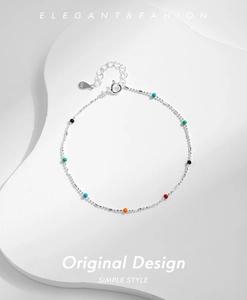 Detail of colorful beads on an S925 sterling silver chain with heart charm and clasp