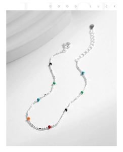Detail of s925 silver beaded bracelet with vibrant colorful enamel beads on a clean base
