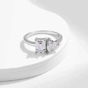 S925 silver ring featuring emerald cut and heart shaped diamond side by side