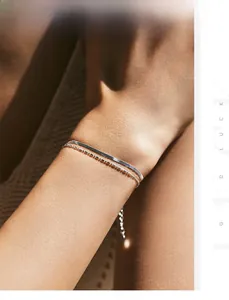 Detail of silver double-layered snake chain bracelet with adjustable extension on wrist