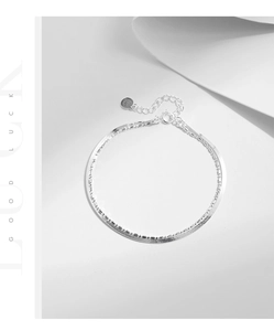 Detail of S925 sterling silver double layer bracelet with flat snake chain and spring clasp