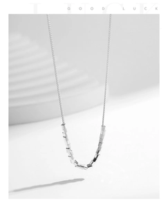 Detail view of S925 sterling silver necklace featuring polished cylindrical bead pendant