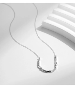 Minimalist S925 silver necklace featuring small cylindrical metal tubes on a fine chain