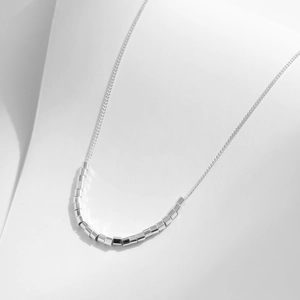 Minimalist S925 sterling silver necklace featuring geometric cylindrical beads on fine chain