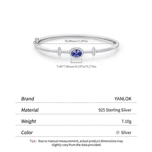 Elegant 925 sterling silver bangle with oval blue gemstone and sparkling zircon accents