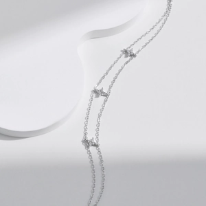 Elegant S925 sterling silver double-layer bracelet with sparkling star charms on white