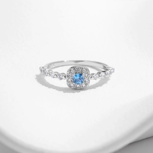 Elegant s925 silver ring featuring a blue square halo crystal and pavé side stones