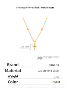 Detail view of gold s925 silver cross necklace with colorful beads and zircon