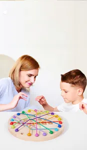 Close-up of children's logic puzzle toy featuring colorful ropes and wooden board