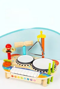 Detail of wooden musical toy set featuring colorful drums, xylophone and triangle instrument