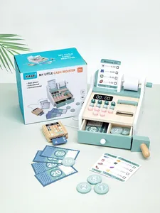 Detail view of a mint green wooden toy cash register set with play money and accessories