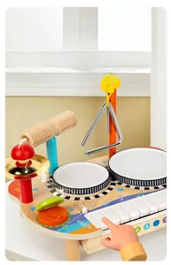 Close-up of wooden musical activity table showing adjustable volume and seven keys
