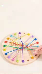 Close-up of colorful elastic ropes threaded through a wooden sensory logic board