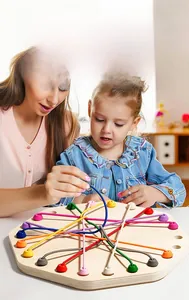 Close-up of mother and child playing with colorful elastic rope puzzle wooden board game