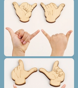 Detail of wooden hand gesture puzzle pieces showing laser-cut textures and natural wood grain