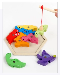 Macro shot of a magnetic wooden fishing rod catching colorful dinosaur toy puzzle blocks