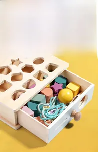 Detail of wooden Montessori toy box with shape sorting lid and colorful blocks