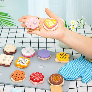 Wooden play food set featuring assorted colorful toy biscuits on a grey tray with an oven mitt