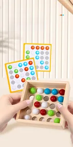 Close-up of wooden logic game tray with colorful beads and challenge cards for kids