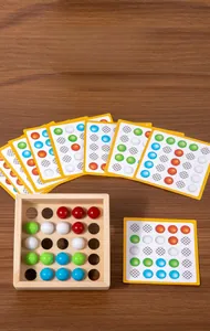 Educational wooden puzzle with colored balls and logic challenge cards for toddlers